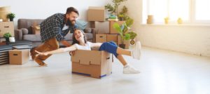 happy young married couple moves to new apartment